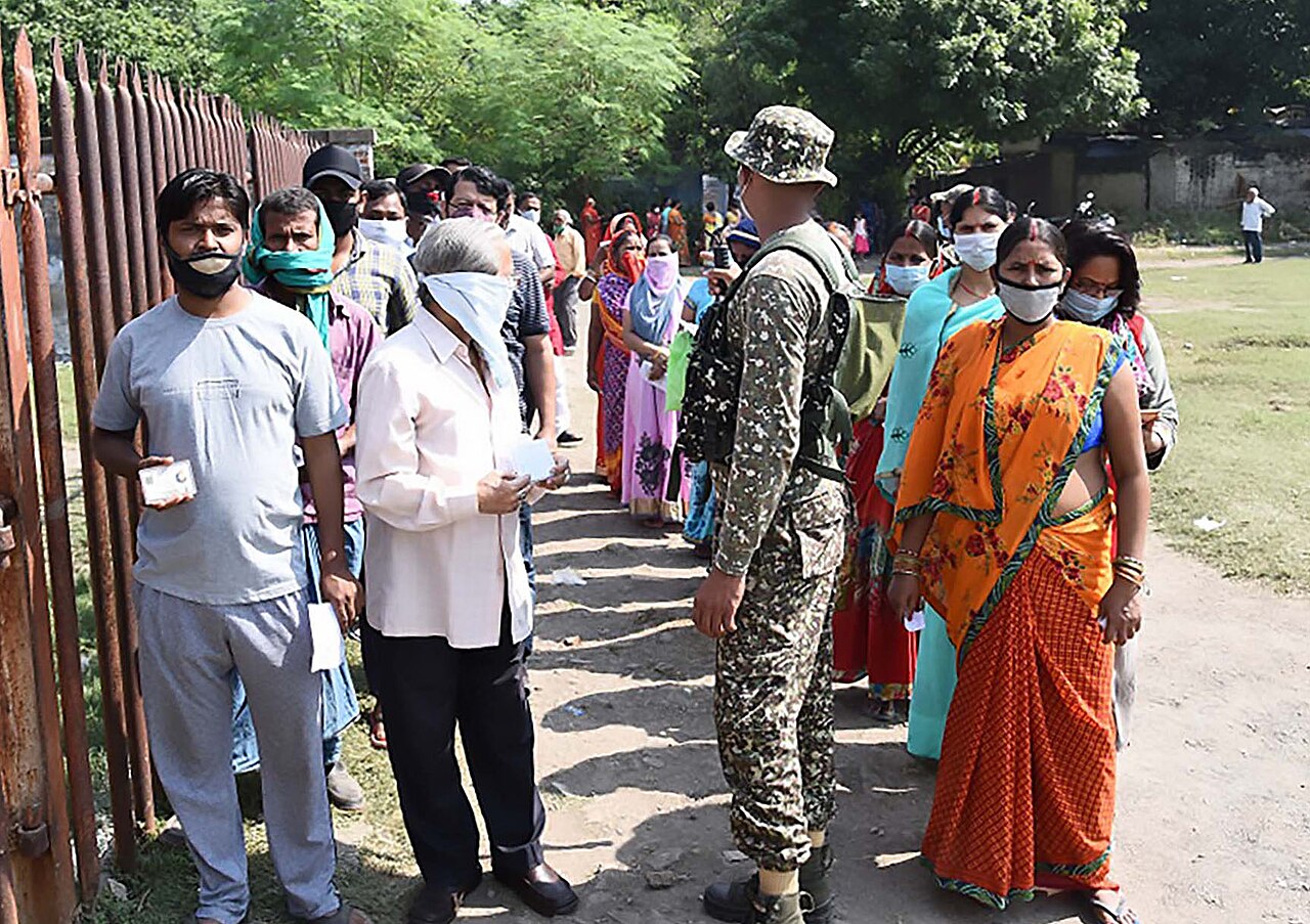 Voters queuing at a polling booth in Gaya, Bihar